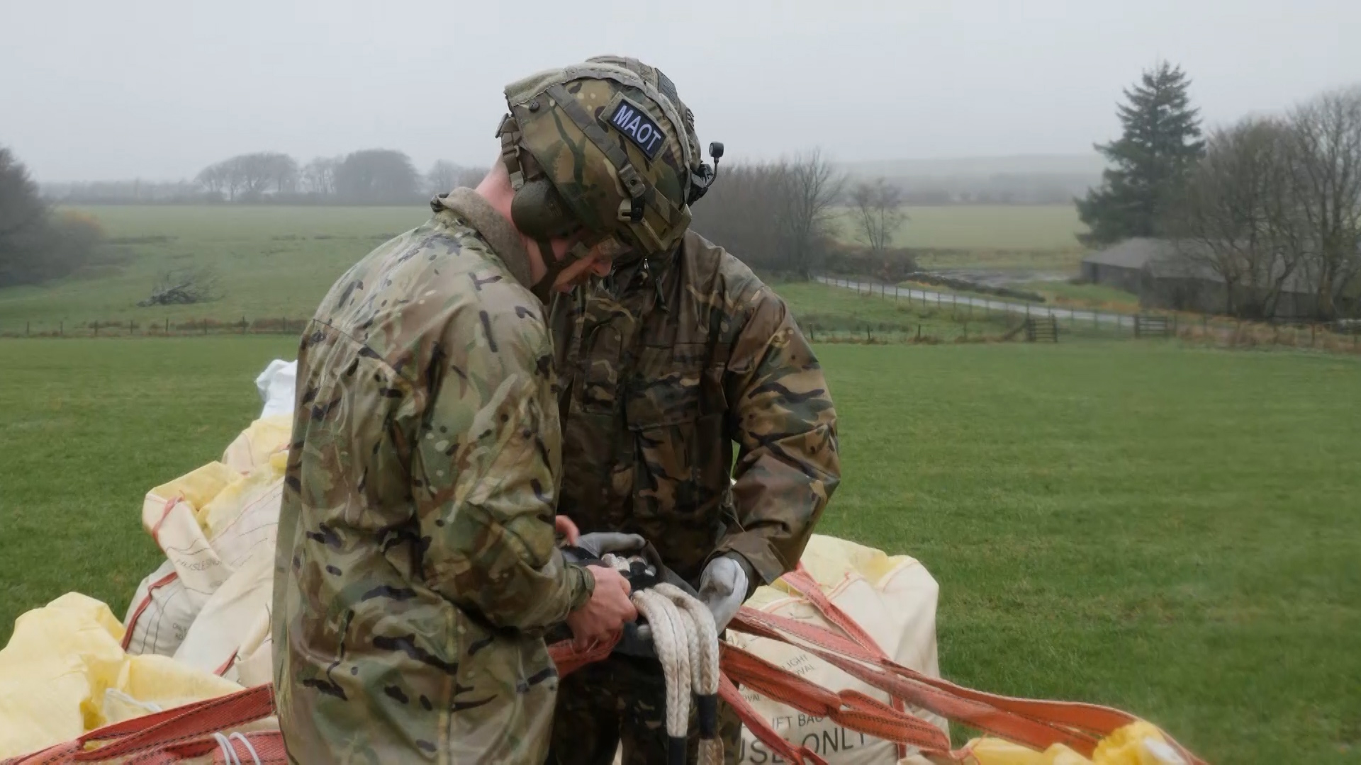 Merlin aircrew prepare the bags to be airlifted.