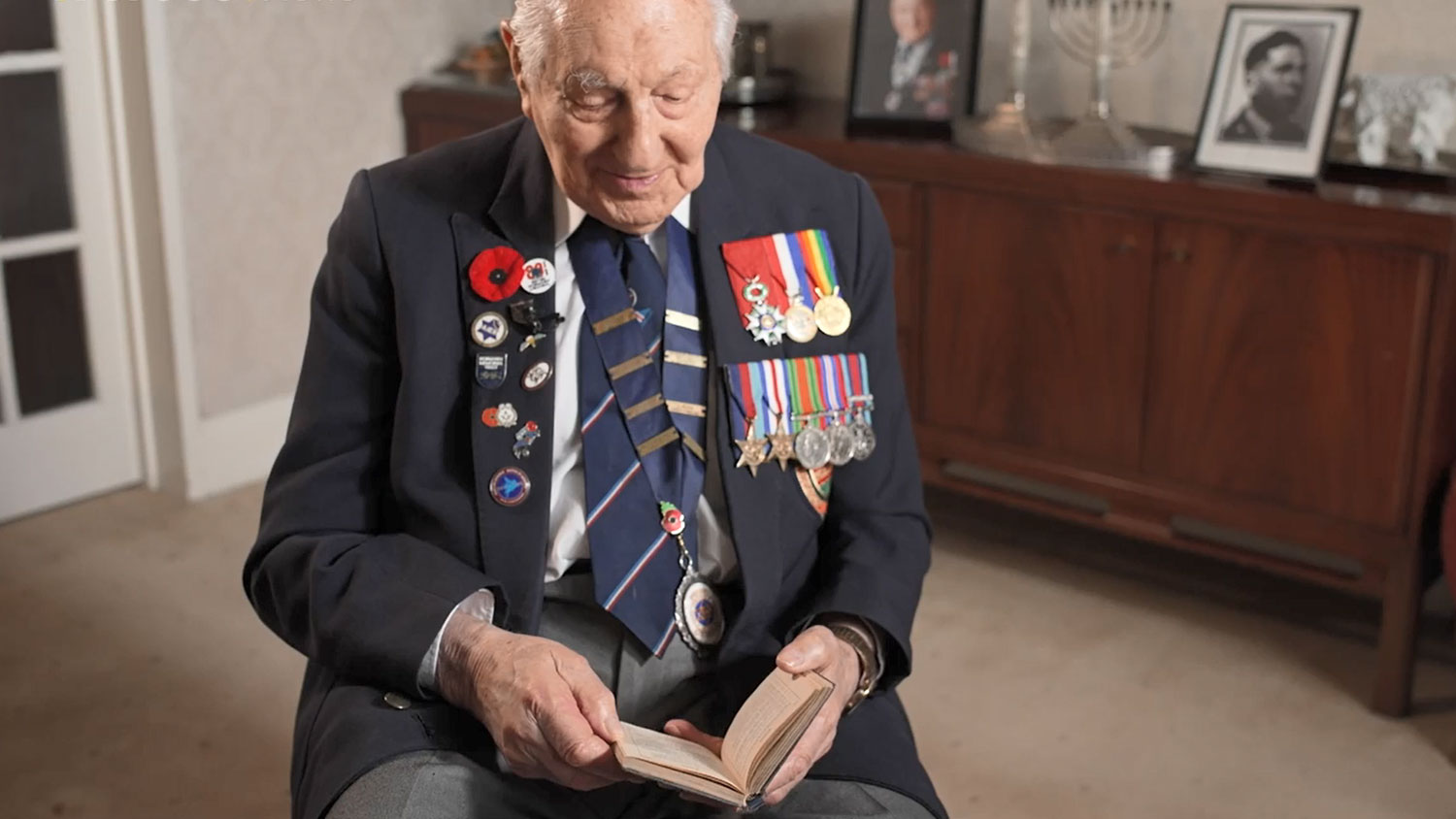 Mervyn Kersh holding his pocket sized WW2 psalms book CREDIT BFBS