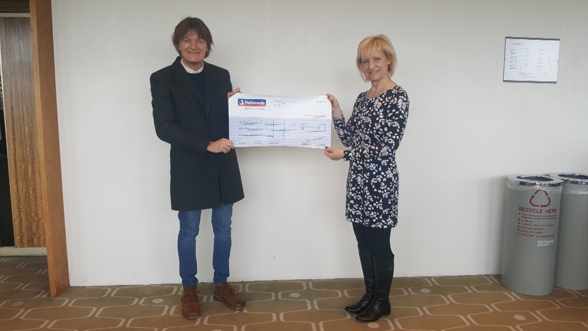 Robbie's son Mike presents The Ripple Pond with a cheque (Picture: The Ripple Pond).