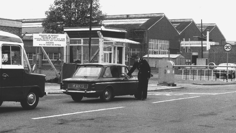 Ministry of Defence Police a consistent force for the last 50 years Officer checking passes at site entrance point UK DATE UNKNOWN Credit MDP.jpg