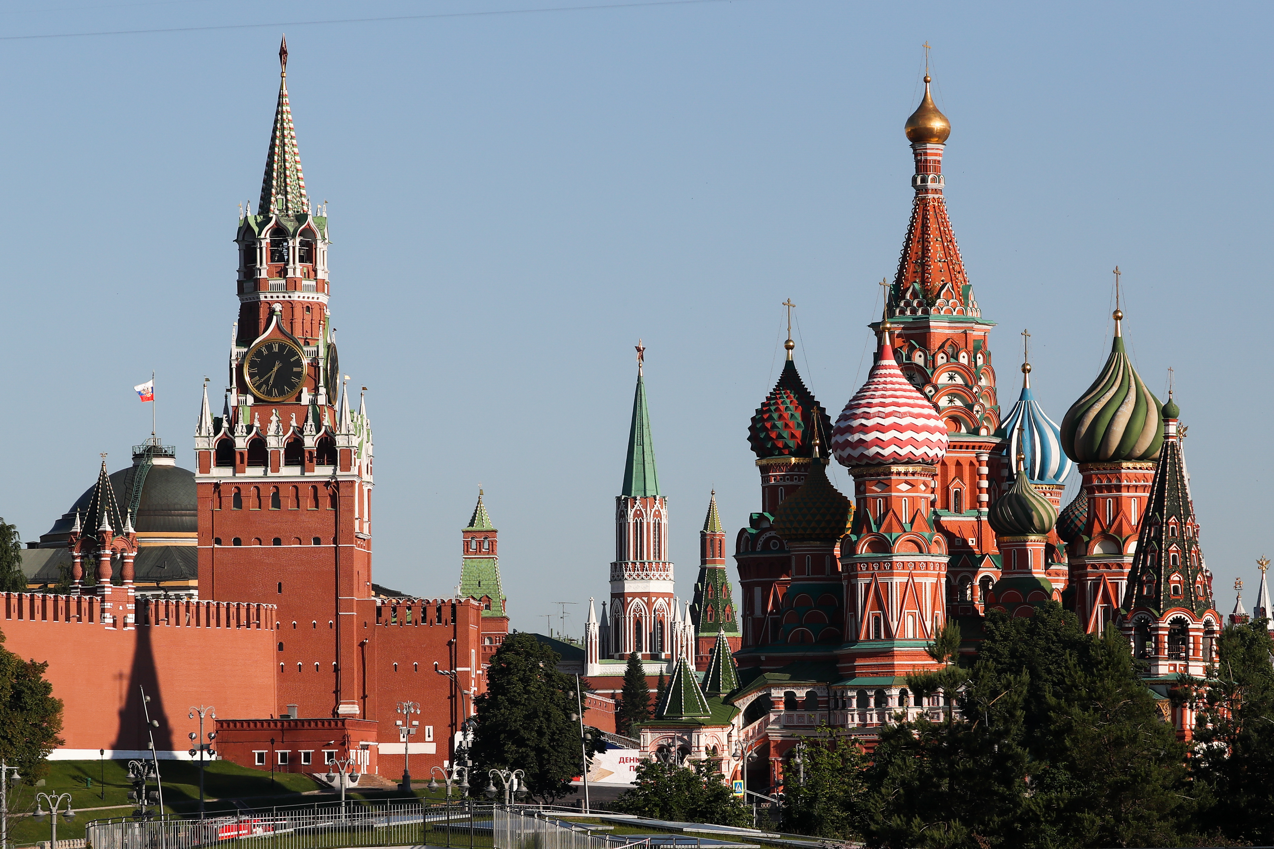 Moscow Kremlin's Spasskaya Tower (L), and St Basil's Cathedral (Picture: PA).
