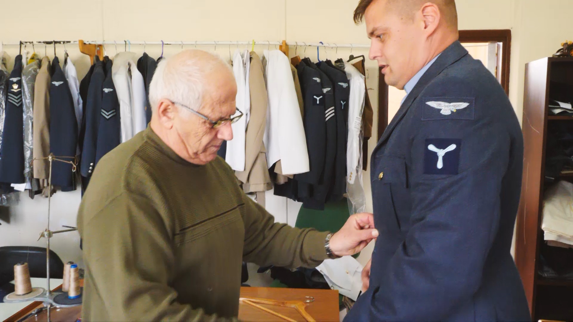 Mr Kasinis measuring a customer's jacket 130219 CREDIT BFBS