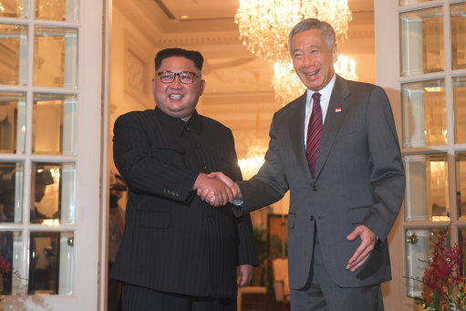 Mr Kim shakes hands with the Singapore Prime Minister (Picture: PA).