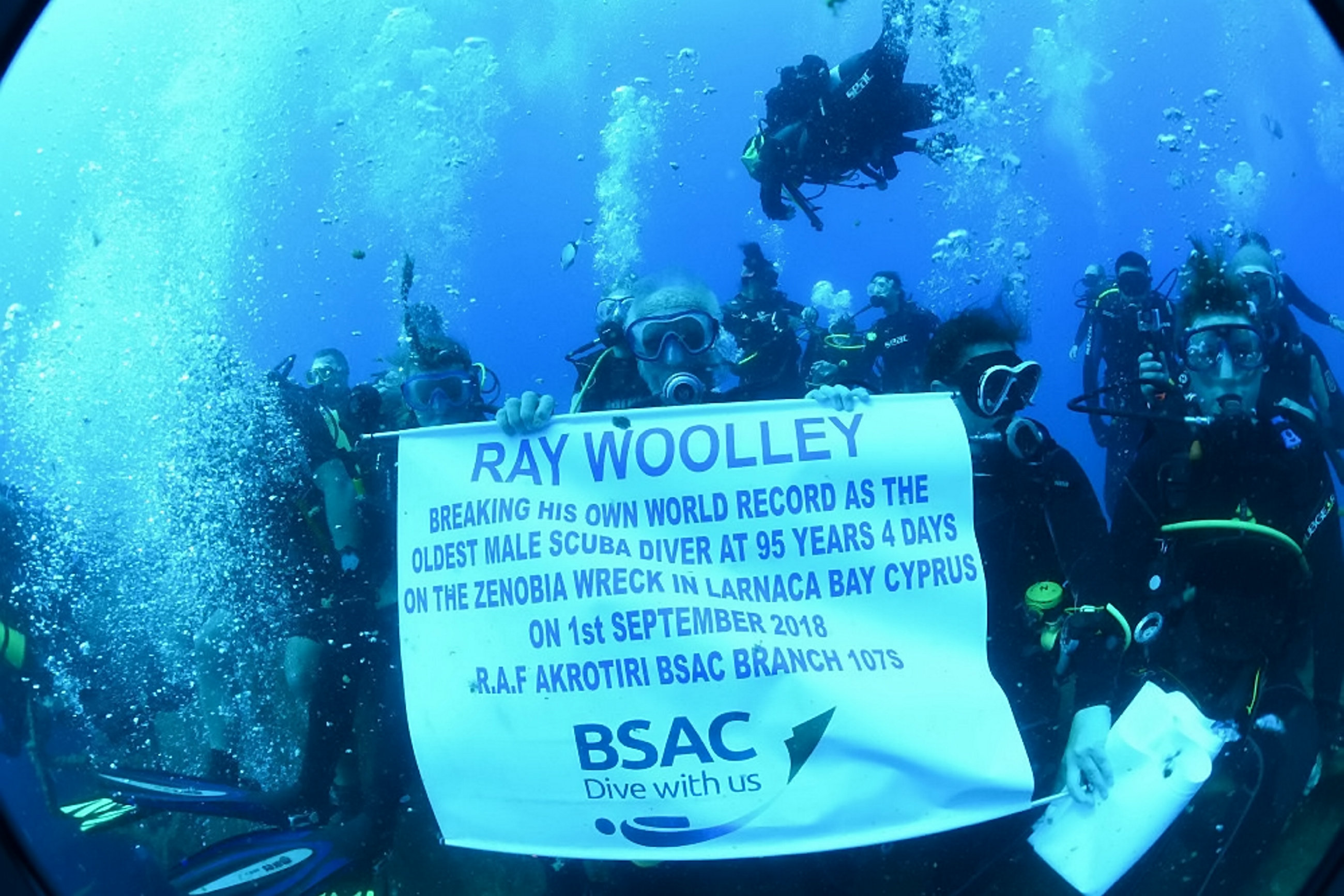 Mr Woolley with other divers celebrating the record (Picture: SWNS).