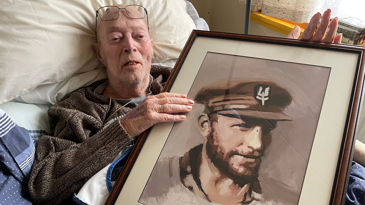Mr Alec Borrie pictured with his framed portrait of Lt Col Paddy Mayne CREDIT Perry Smith