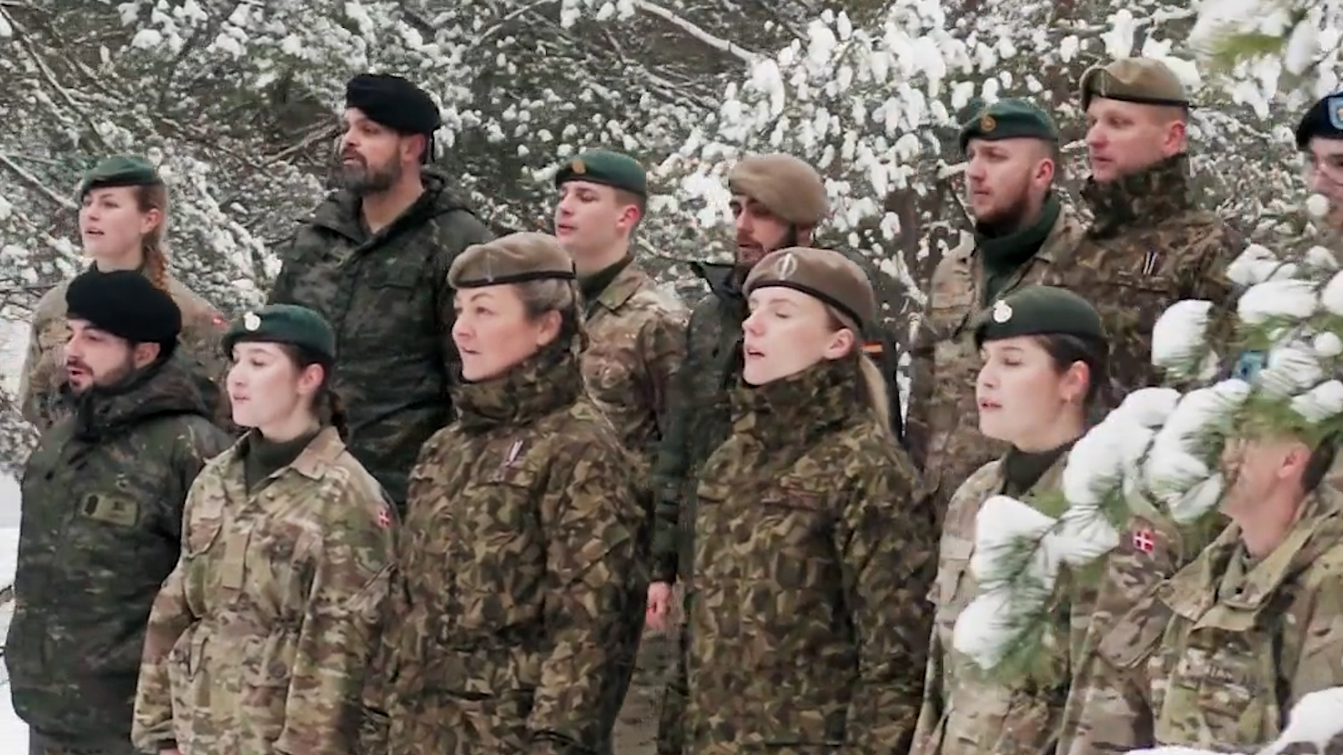 	Multinational group of NATO personnel singing Christmas carol