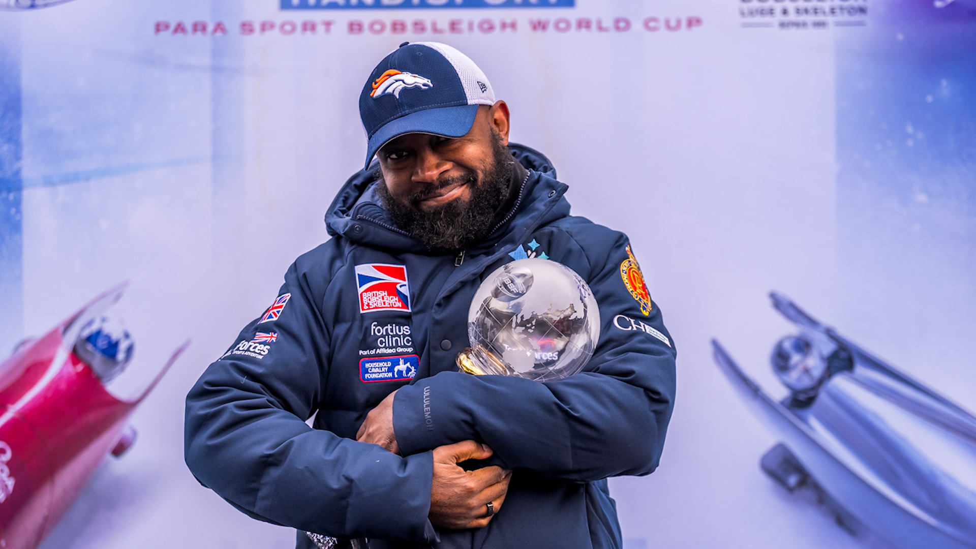 Corie Mapp holds globe trophy after world cup win
