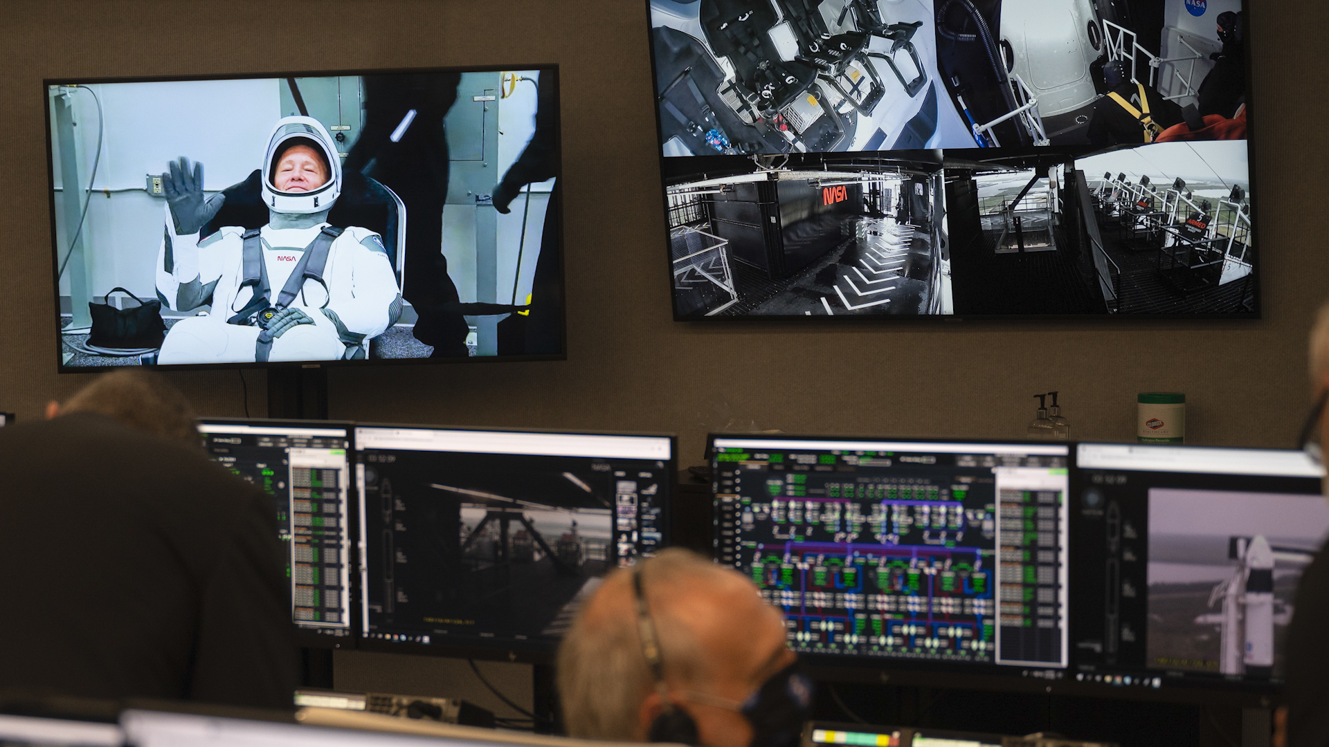 NASA astronaut Douglas Hurley is seen waving on a monitor in firing room four during suit-up at the Neil A. Armstrong Operations and Checkout Building 270520 CREDIT NASA.jpg