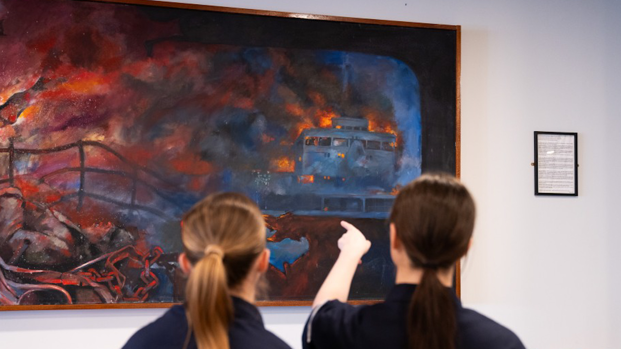 Navy recruits point out the image of RFA Sir Galahad after it had been bombed (Picture: MOD).