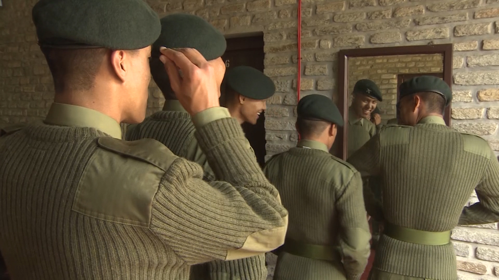 New recruits look at themselves wearing their Gurkha uniforms 070219 CREDIT BFBS.jpg