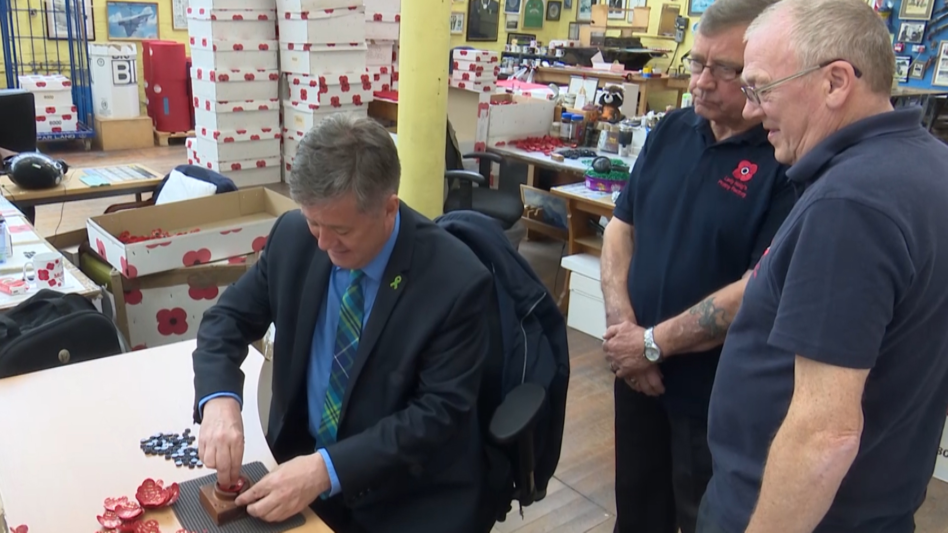 Scottish Veterans Minister Keith Brown making a commemorative poppy
