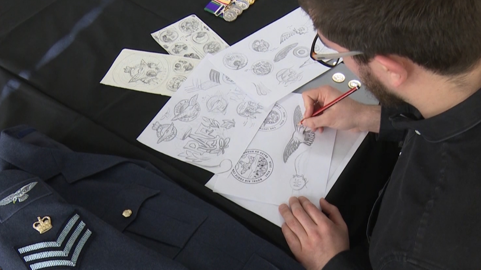 Royal Mint graphic designer working on special RAF coin