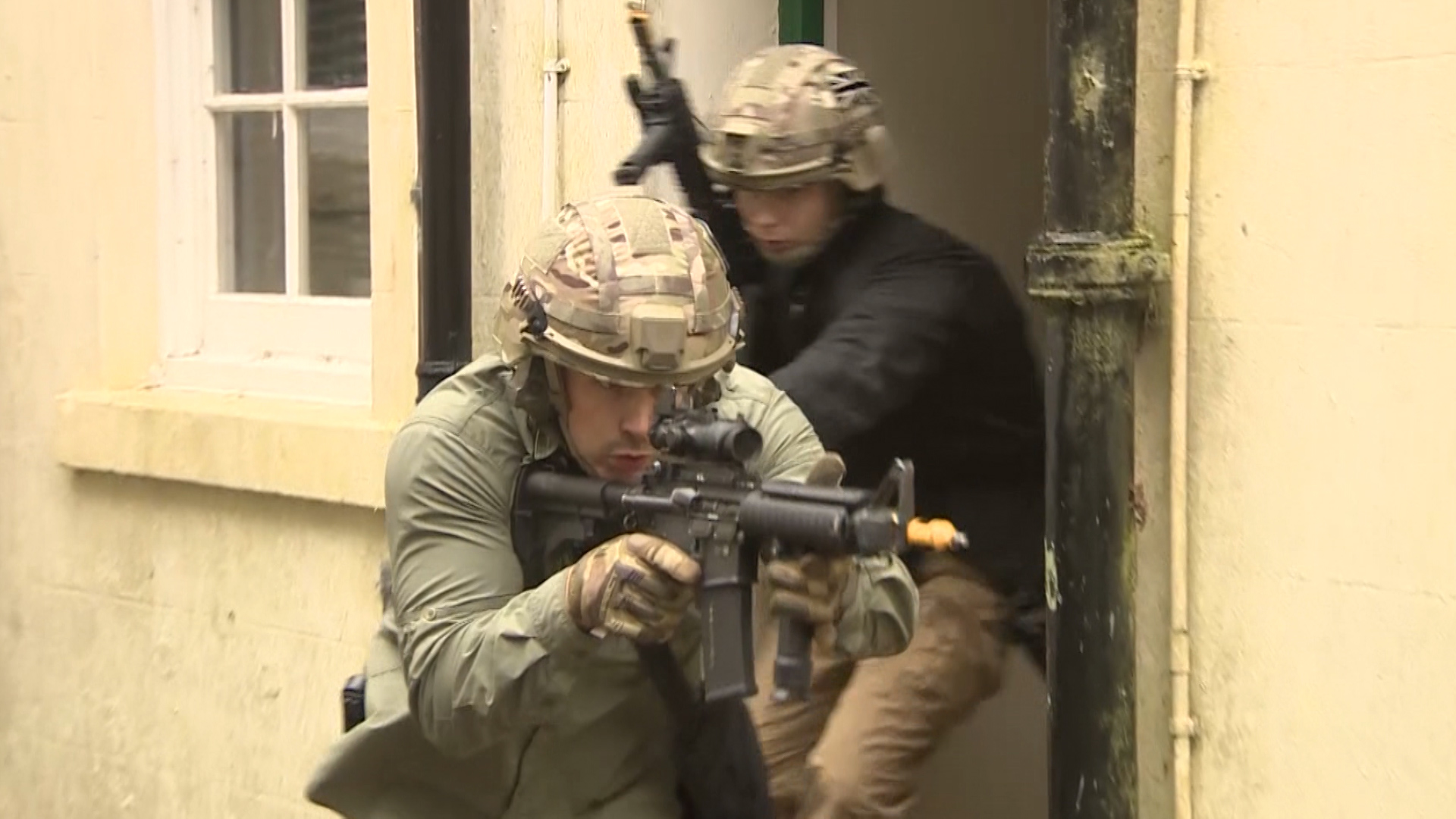RMP Close Protection Unit officers exit a building