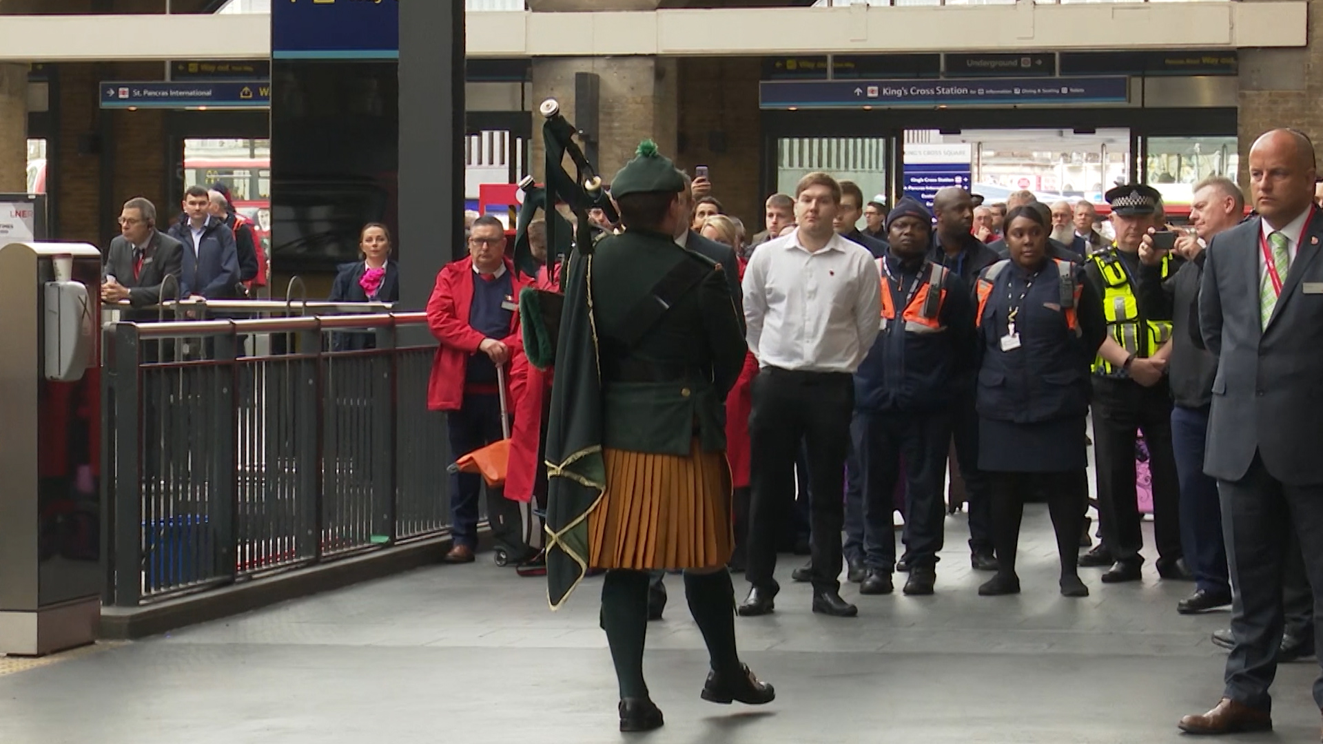 Piper performs last post at Kings Cross Station