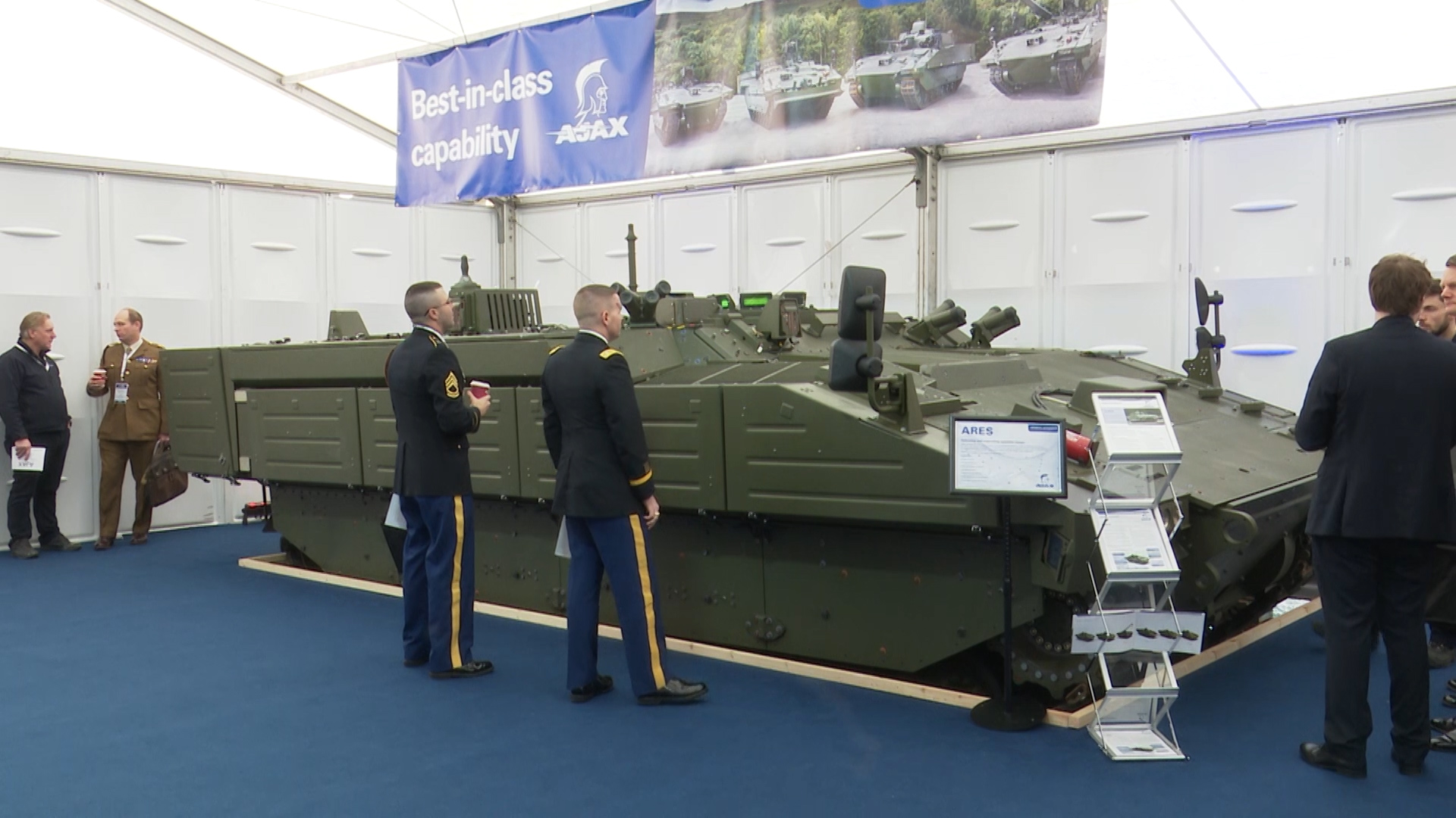 Next Generation Of Military Vehicles Are Showcased At London Exhibition Soldiers look at Kit 230119 CREDIT BFBS .jpg	