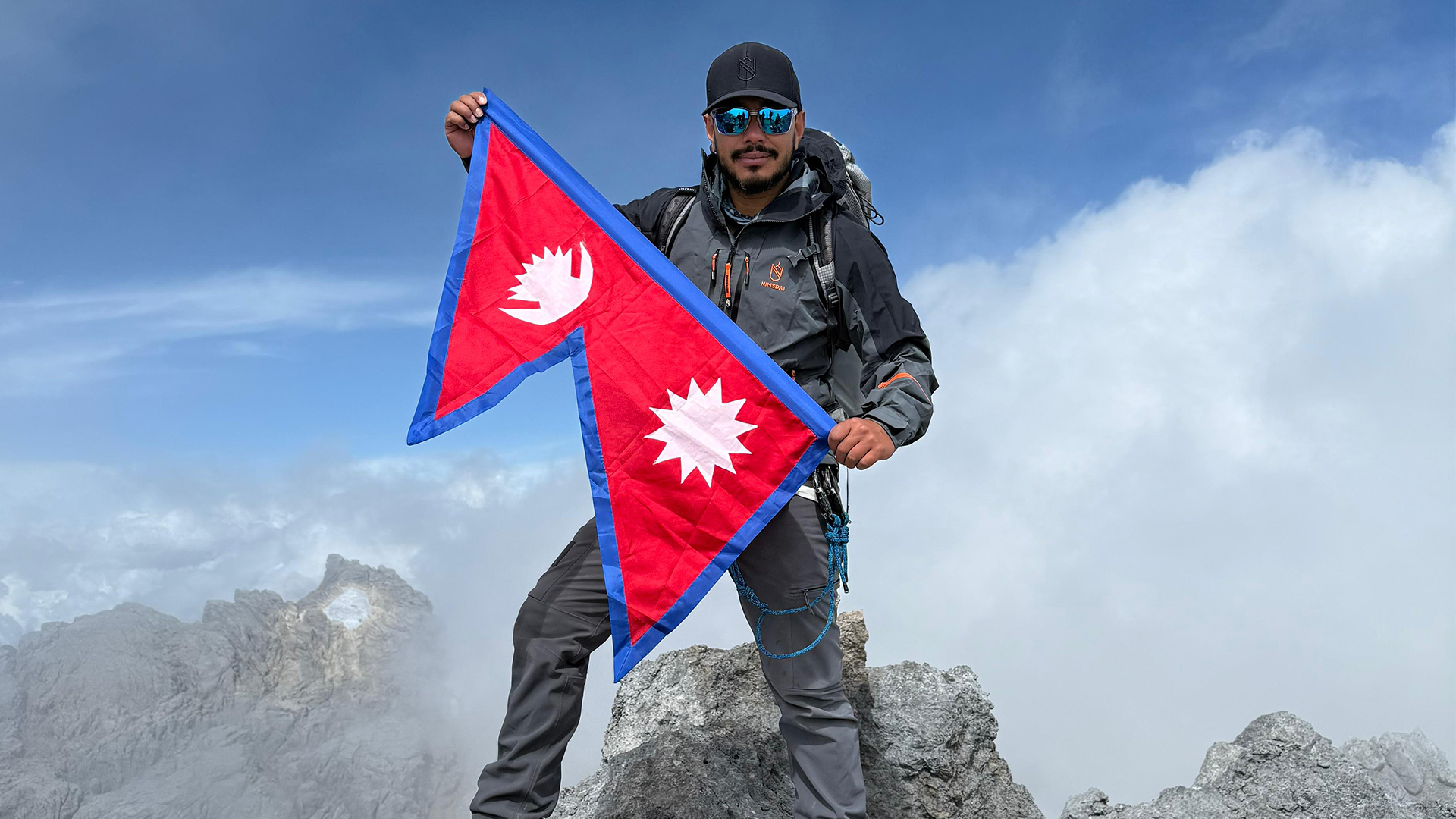 Nimsdai Purja flies the double-pennon national flag of Nepal from the summit of Carstensz Pyramid (Picture: Nimsdai Purja)