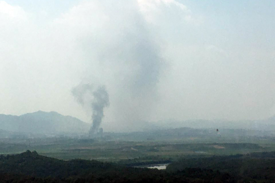 Cover image: Smoke rises from the inter-Korean office in Kaesong following the demolition (Picture: Yonhap/PA).