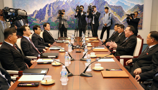 Officials from the Koreas speak at Panmunjom (Picture: PA).