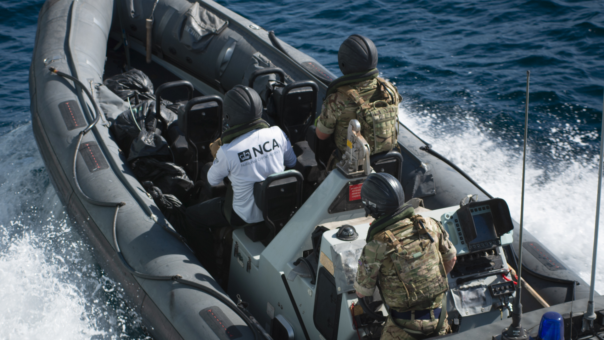 One of HMS Montrose's boats returns to the ship with some of the drugs haul