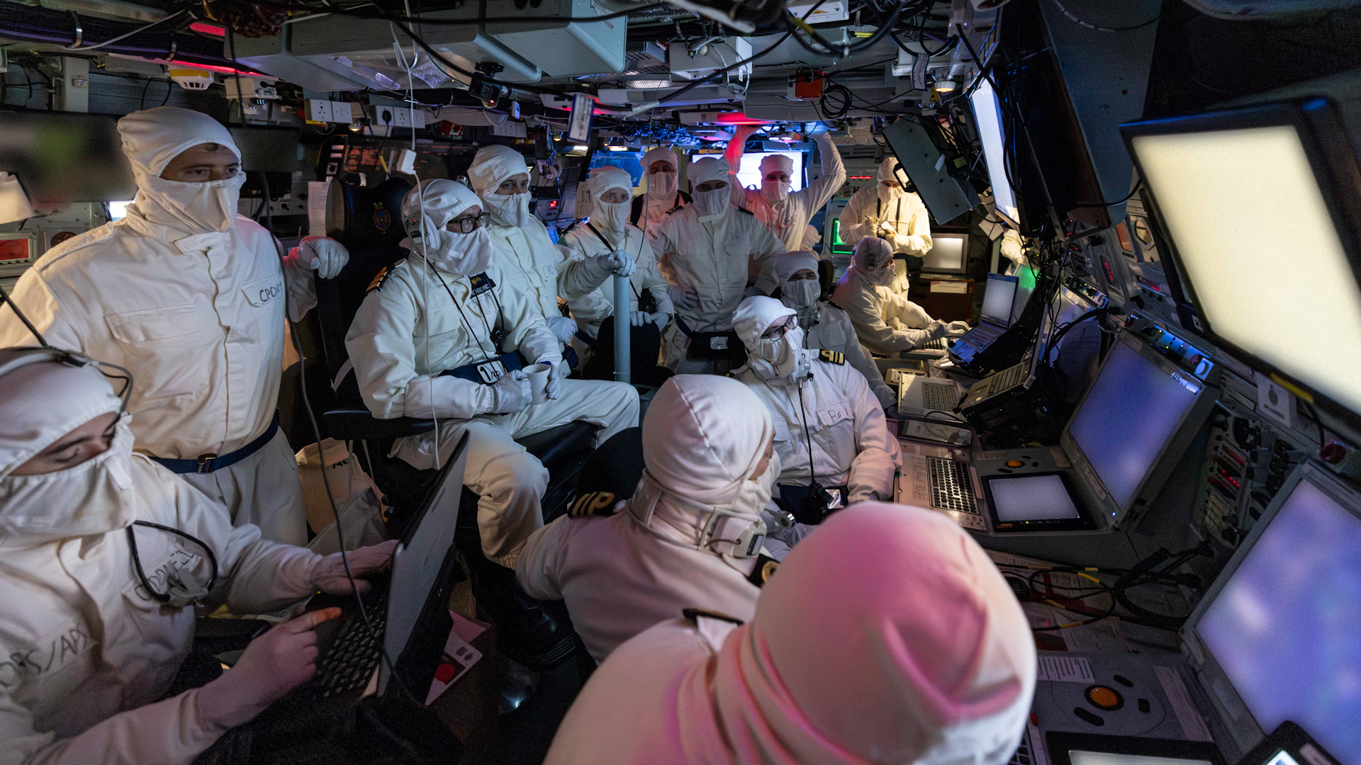 Personnel can be seen wearing white overalls, which are used in combat situations, inside HMS Richmond's operations room