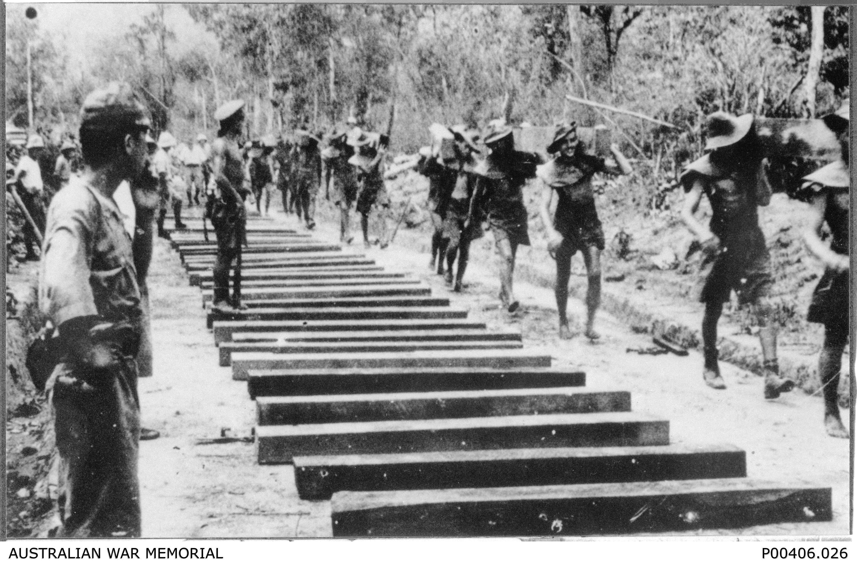 Burma-Thailand Railway. c. 1943. Prisoners of War (POWs) carrying sleepers in Burma, about forty kilometres south of Thanbyuzayat (probably Beke Taung). Credit: Australian War Memorial (Donor A. Seary) - P00406.026