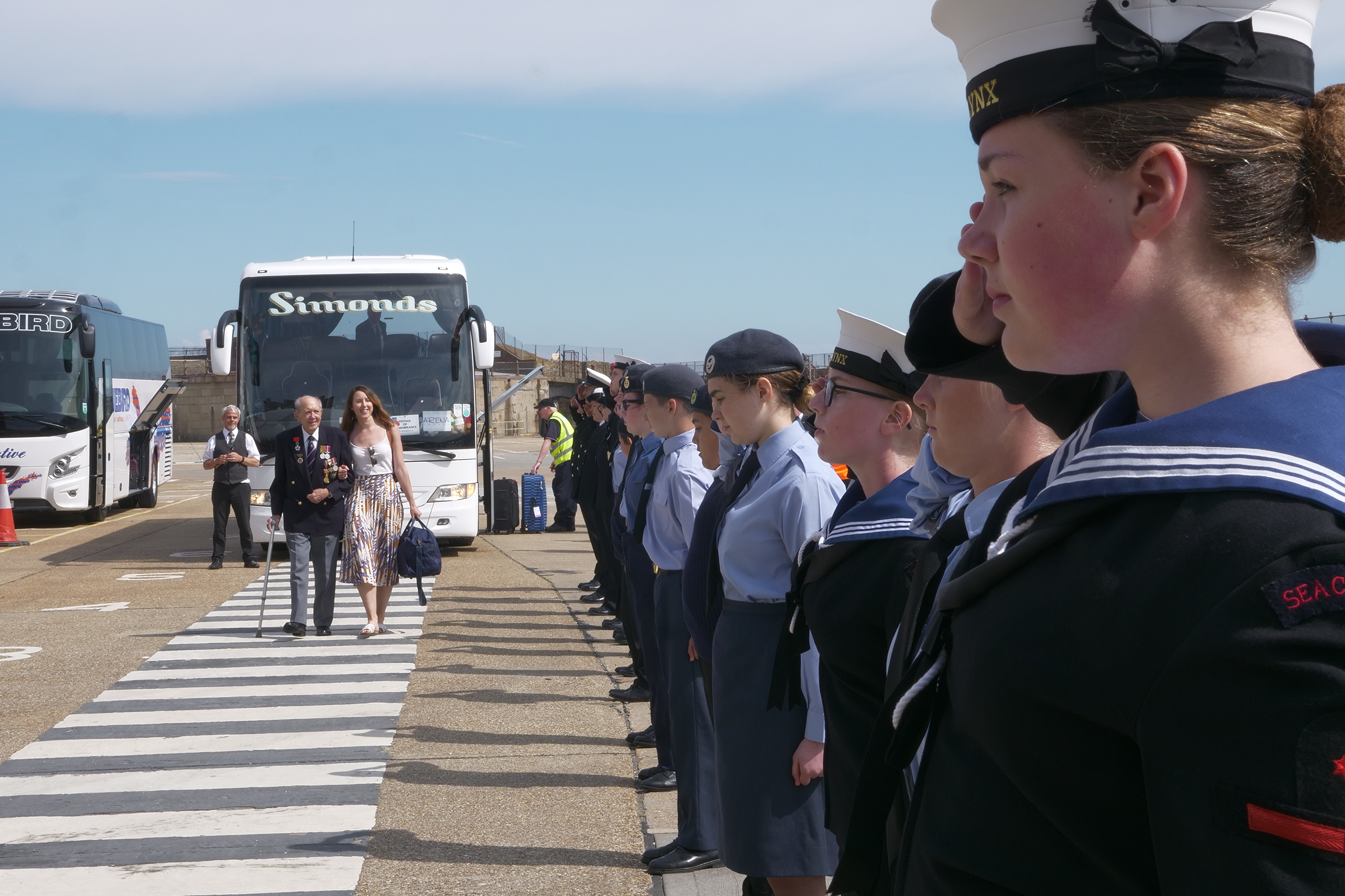 Cadets saluting D-Day Veterans as they enter cruise terminal 