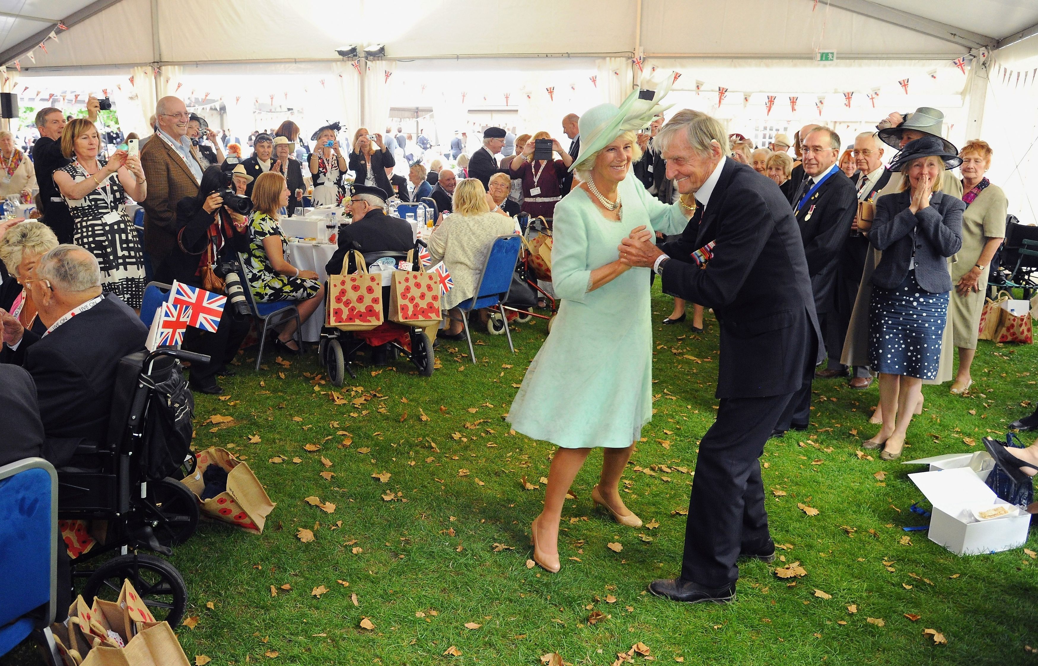 The Duchess of Cornwall dances with D-Day veteran Jim Booth CREDIT: PA Images