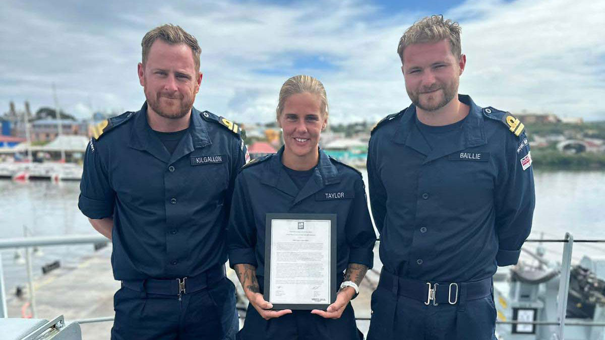 PO Taylor with her citation flanked by Lt Mike Kilgallon and Lt Braddan Baillie CREDIT Royal Navy