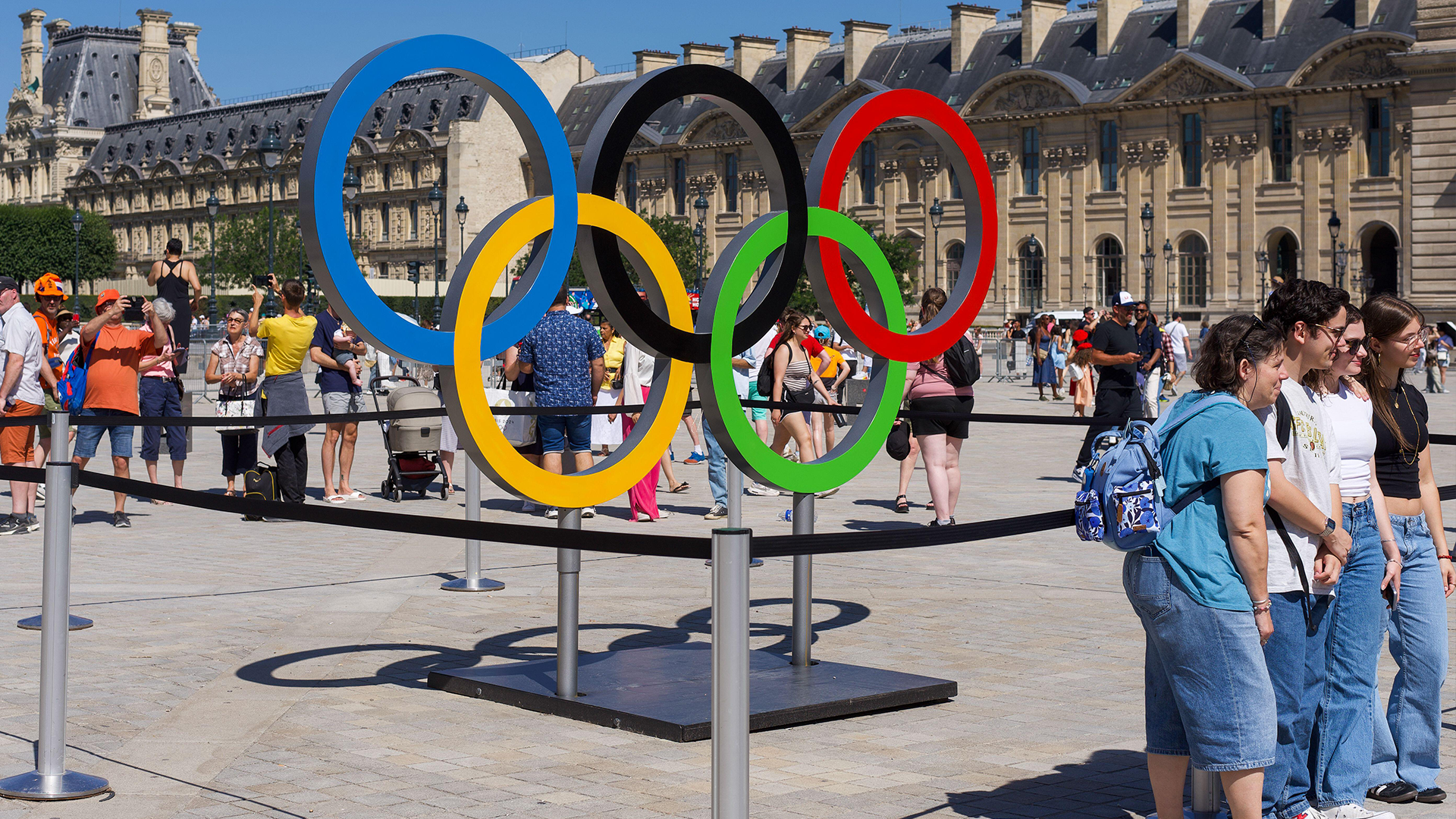 Paris, France, 08.05.2024 People pose and take pictures of the Olympic rings in Paris on a very warm and sunny day CREDIT ALAMY