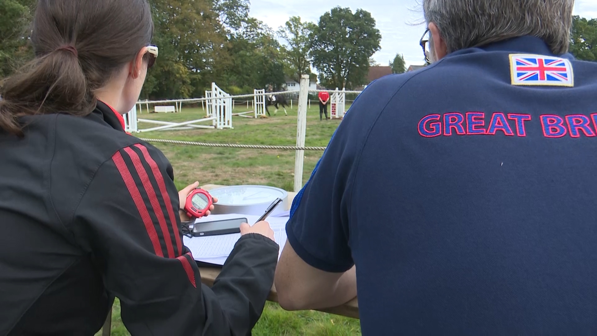 Judges score the horse riders.