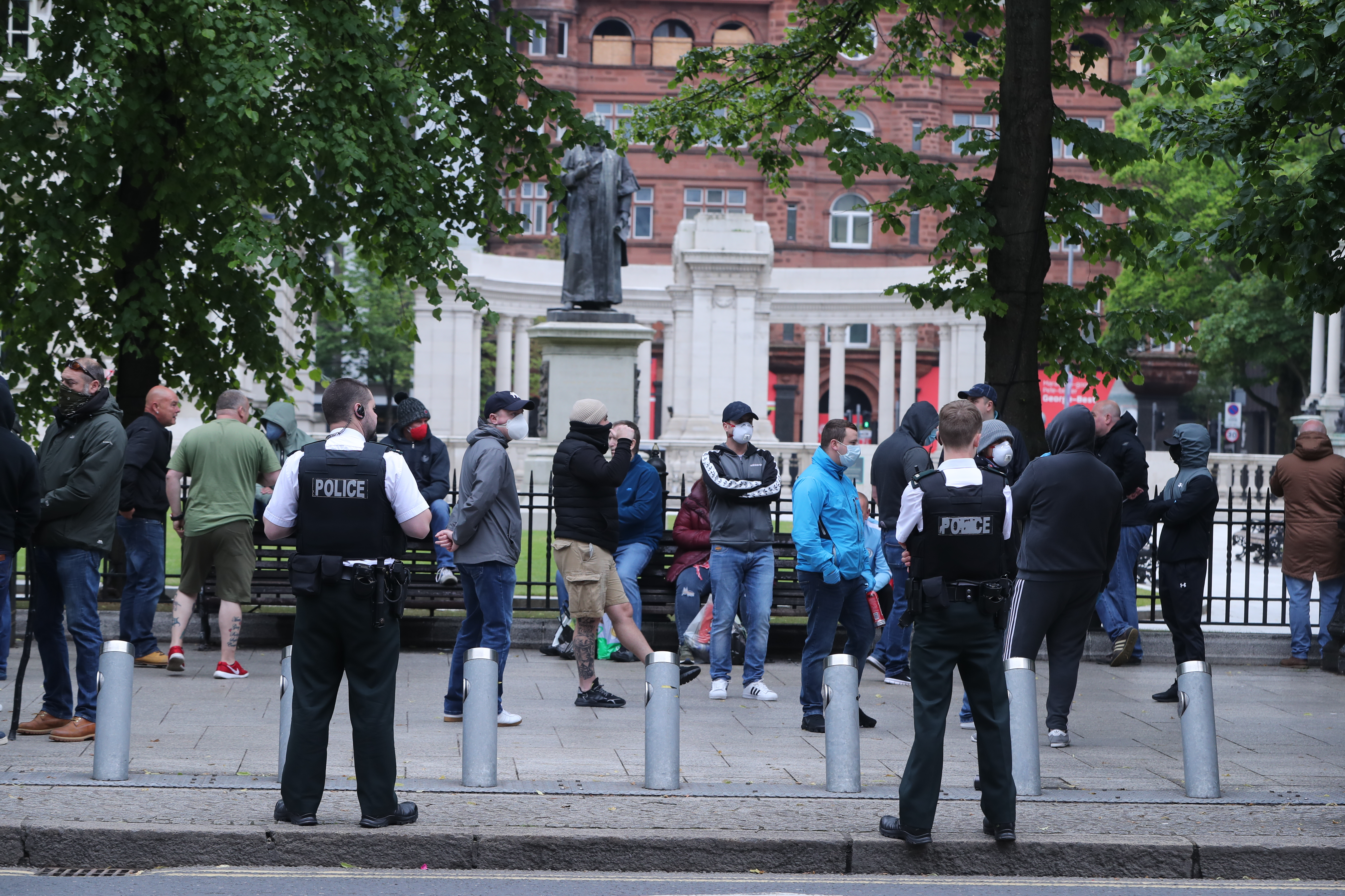 People outside City Hall in Belfast in Northern Ireland to the protect war memorials in its grounds (Picture: PA).