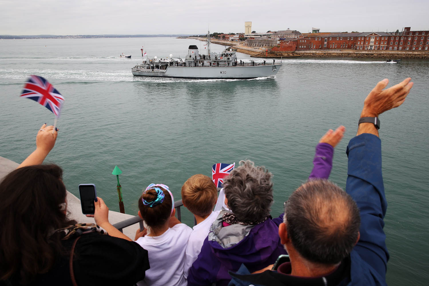 Cover image: People wave as HMS Ledbury arrived back in Portsmouth (Picture: Royal Navy).
