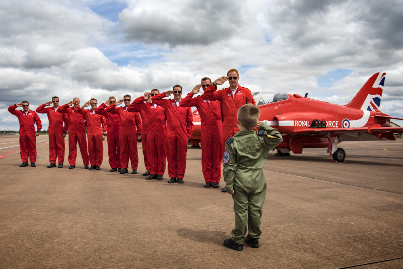 Jacob Newson (5yrs) takes a salute from his heroes the Red Arrows pilots, at the Royal International Air Tattoo at RAF Fairford.