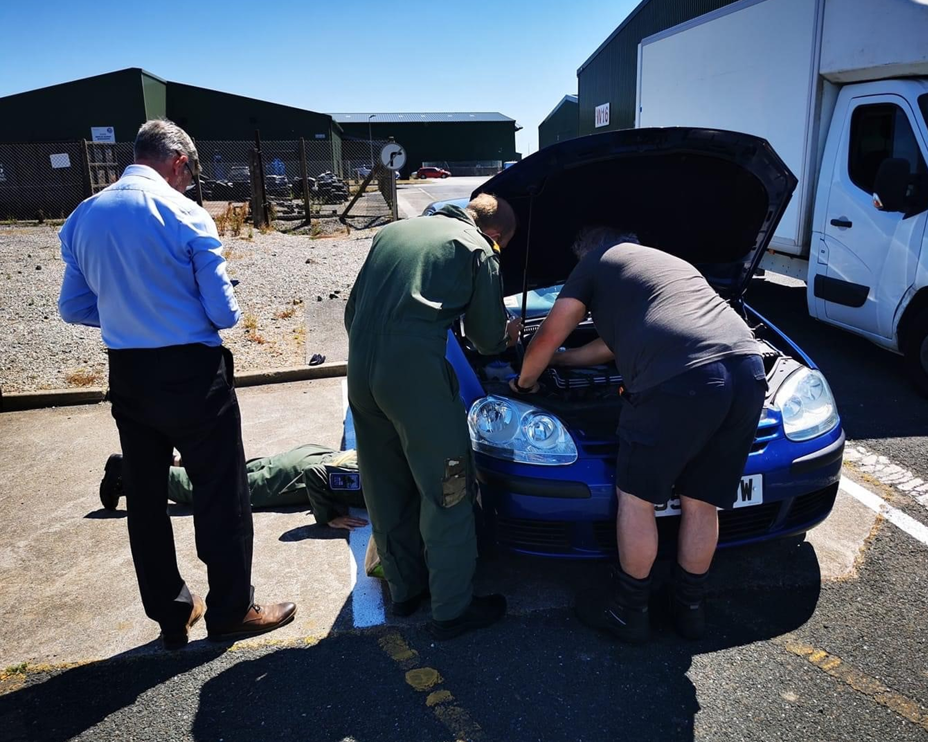 Personnel at RNAS Culdrose attempt to free Fergie the kitten from a VW Golf