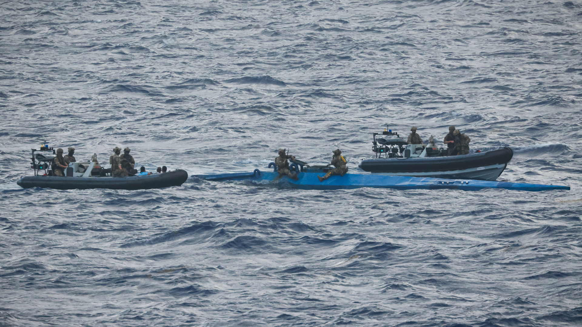	Personnel from HMS Trent seizing drugs from a narco submarine 