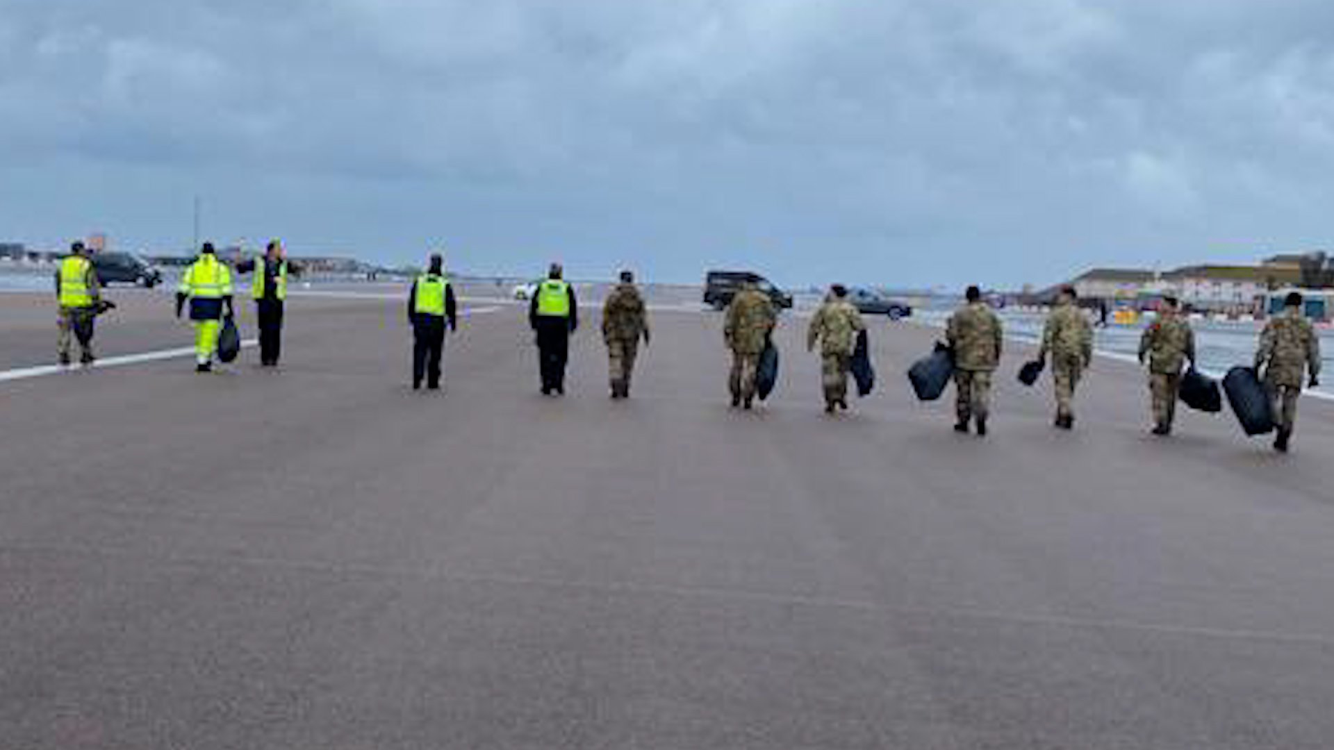 Personnel help to clear sea debris from runway at RAF Gibraltar (Picture: RAF Gibraltar).