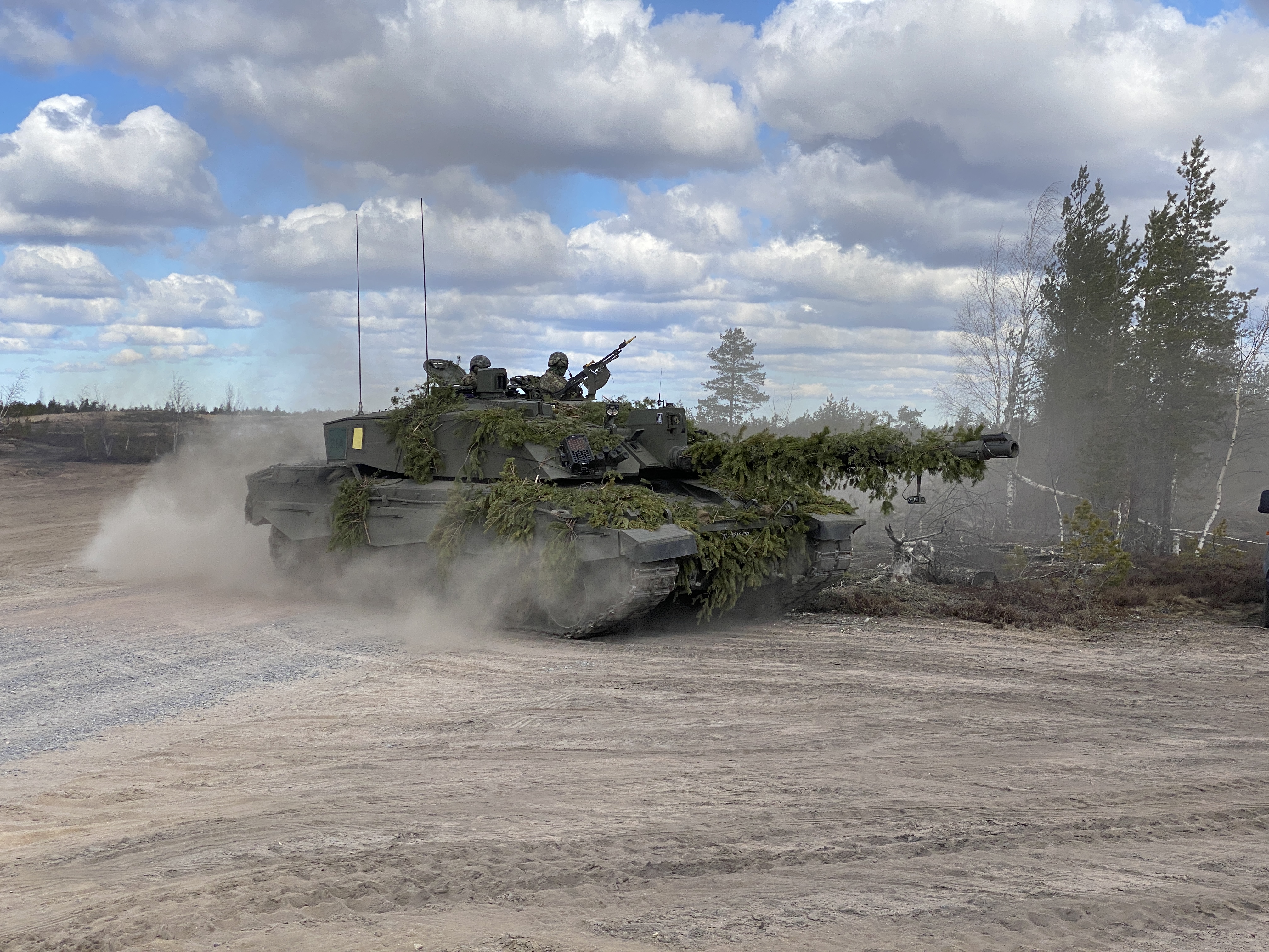 Personnel in a Challenger 2 tank carrying out maneouvres as part of Exercise Arrow 22 in Finland.