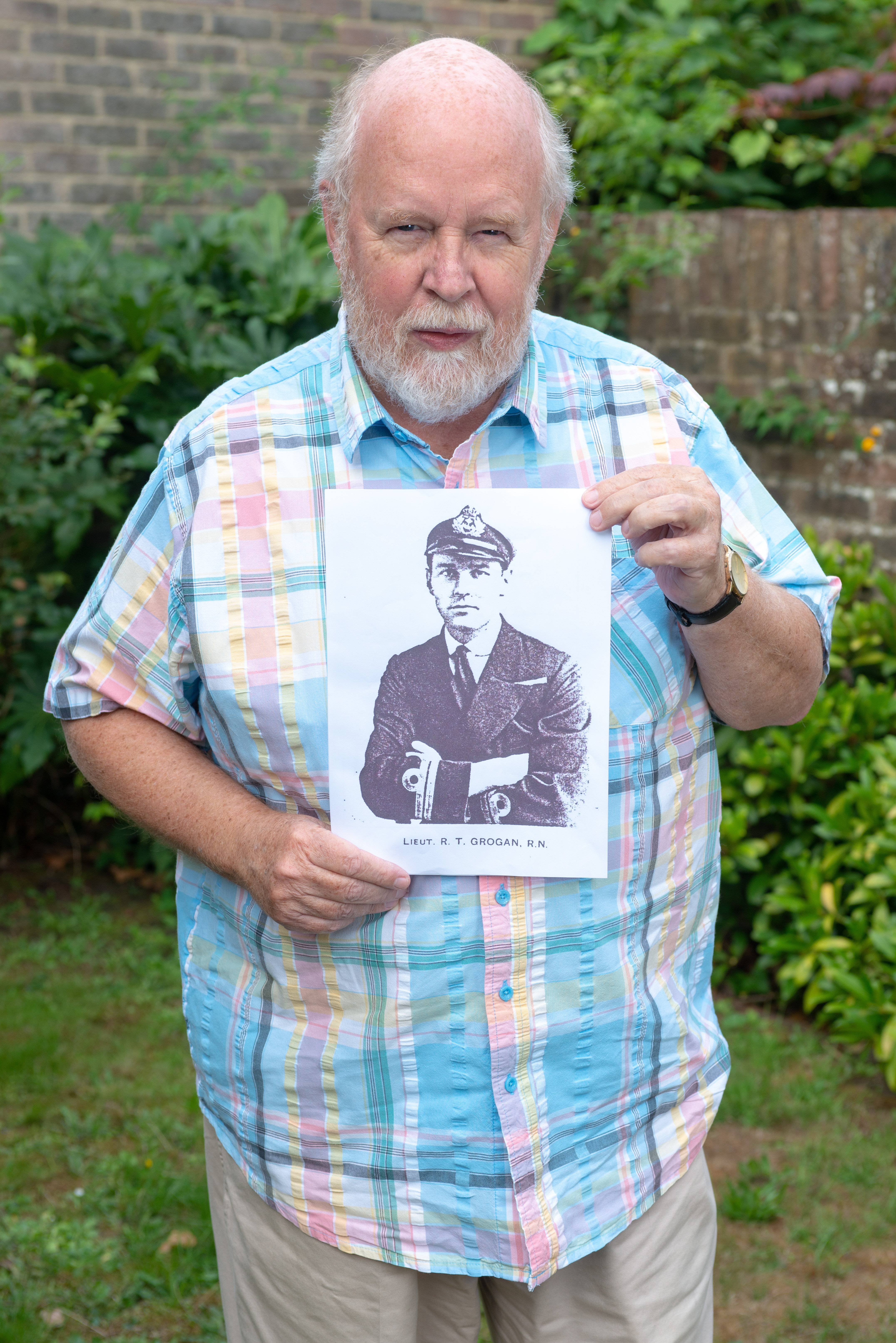 Peter Jefferson with a photo of his uncle Robert Terence Grogan sailor on HMS Hood CREDIT SWNS.jpg