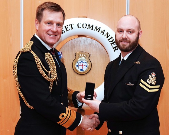 Vice Admiral Ben Key CBE presents Petty Officer Aaron Smith with the Queens Commendation for Valuable Service