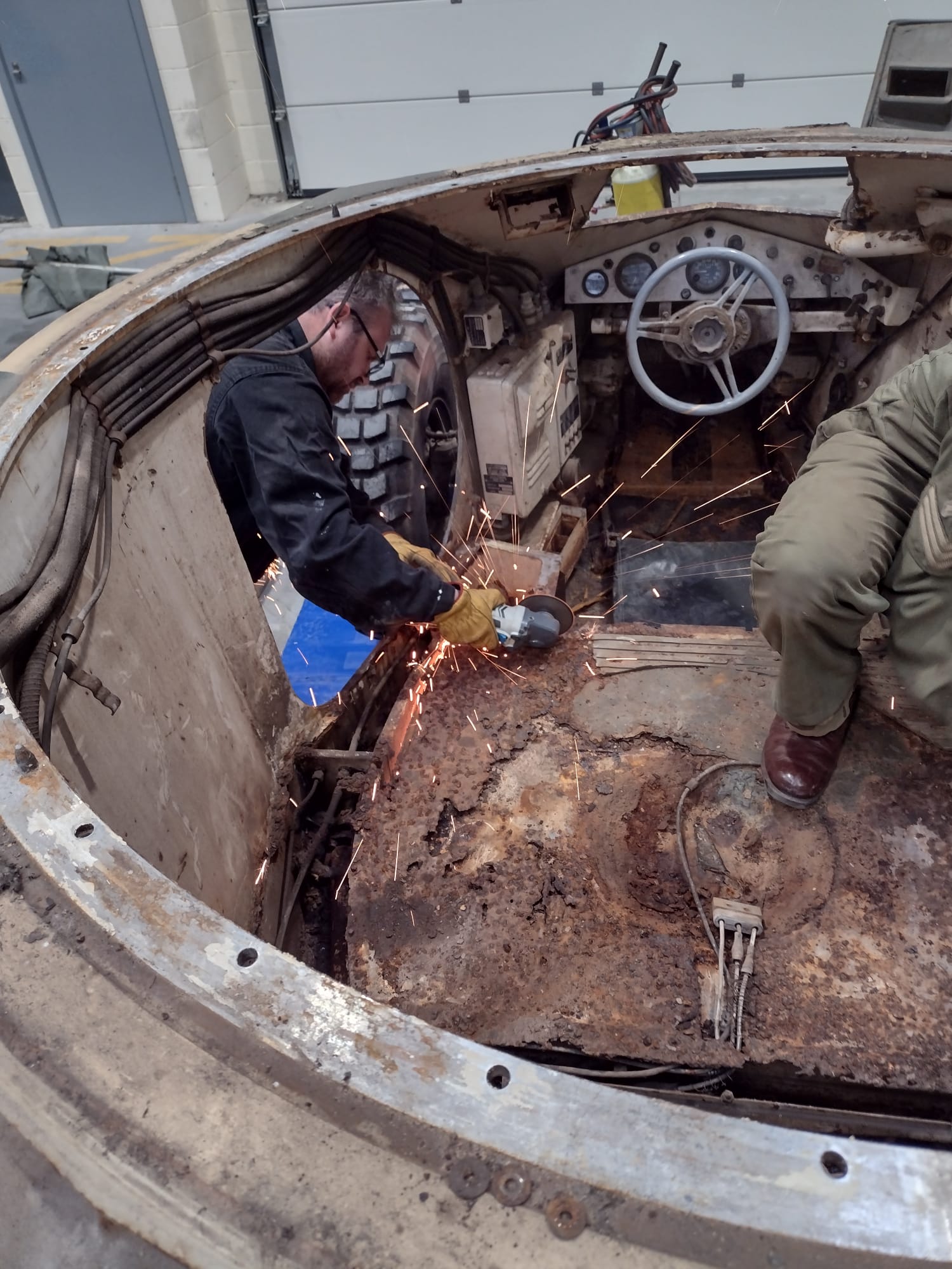 The volunteers addressing some of the ex-Argentine Army vehicle's many defects. Picture: Stephen Cleator.