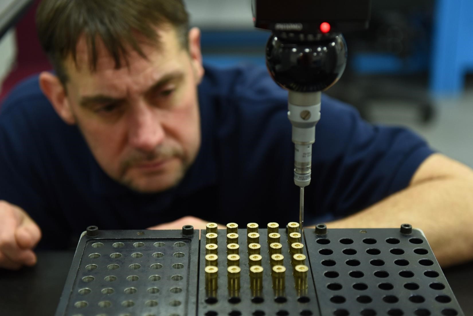BAE Systems employee inspects ammunition production in factory