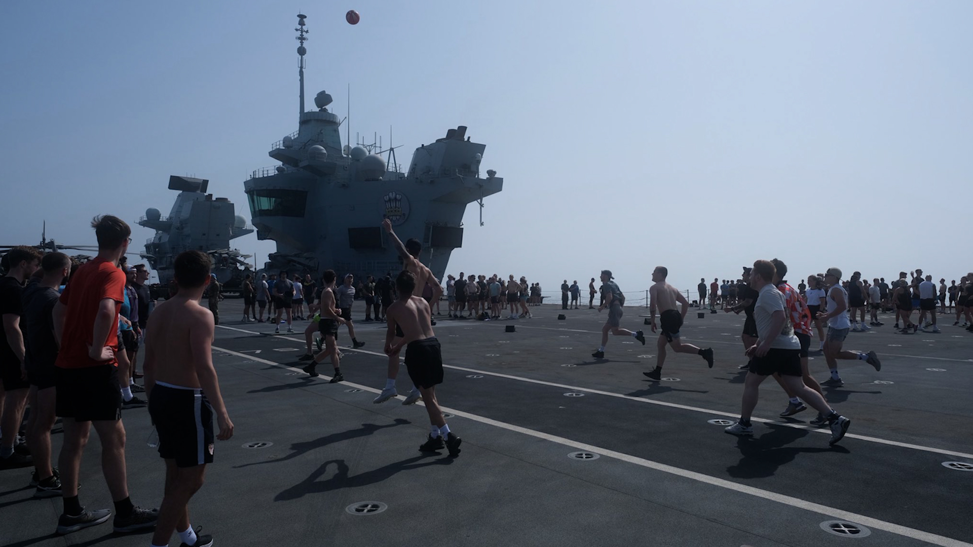 The crew of HMS Prince of Wales play bucketball on the flight deck