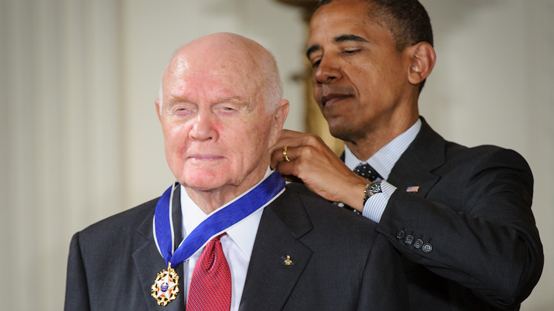 President Barack Obama presents former United States Marine Corps pilot, astronaut, and United States Senator John Glenn with a Medal of Freedom