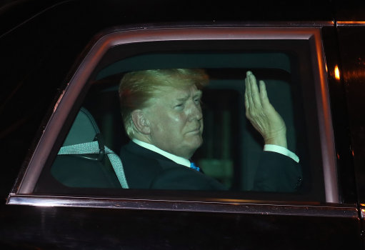 Mr Trump waves as he heads to his hotel (Picture: PA). 