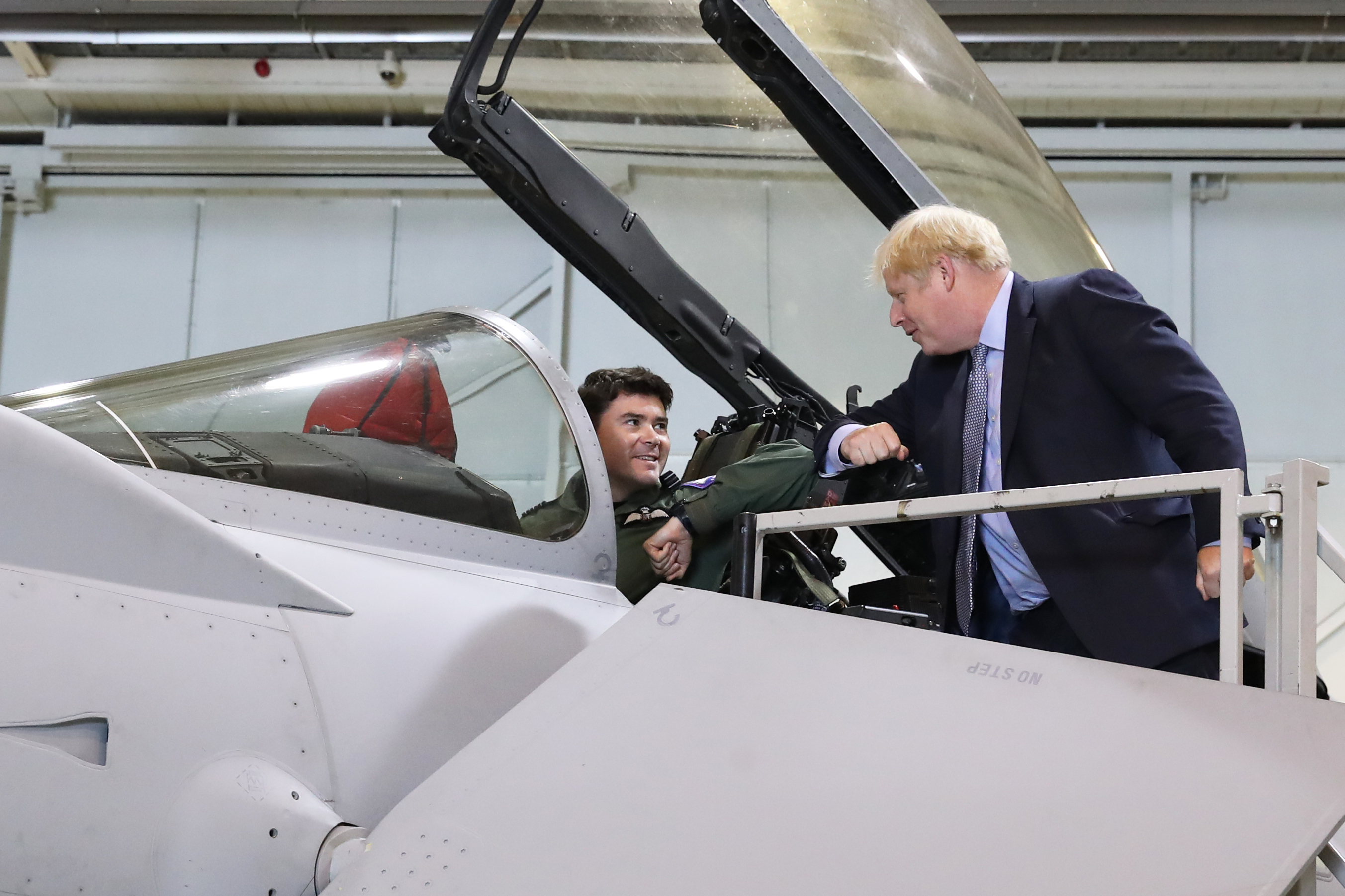 Prime Minister Boris Johnson speaks to a pilot sitting inside a Typhoon fighter jet at RAF Lossiemouth (Picture: PA).