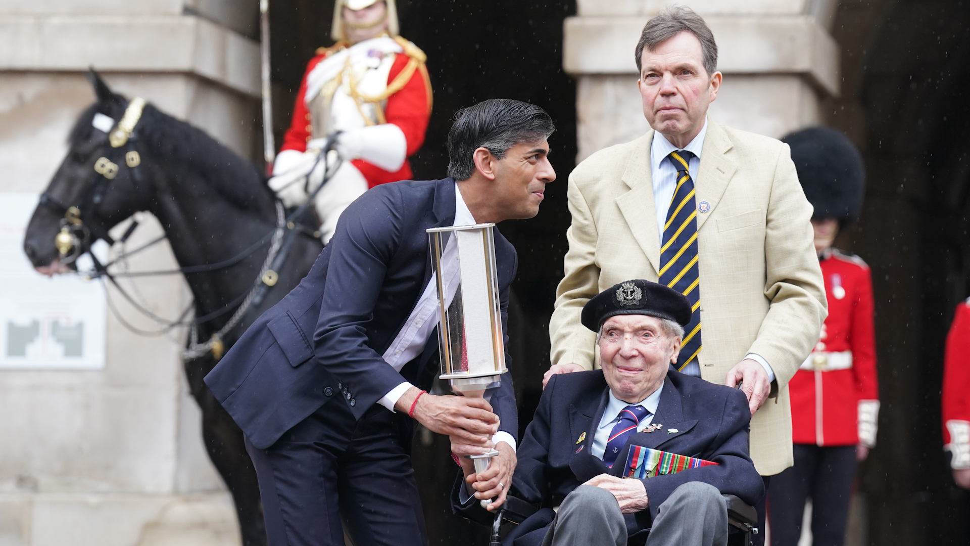 Rishi Sunak hands the Commonwealth War Graves Commission's Torch of Commemoration to Royal Navy D-Day veteran Peter Kent (Picture: PA)