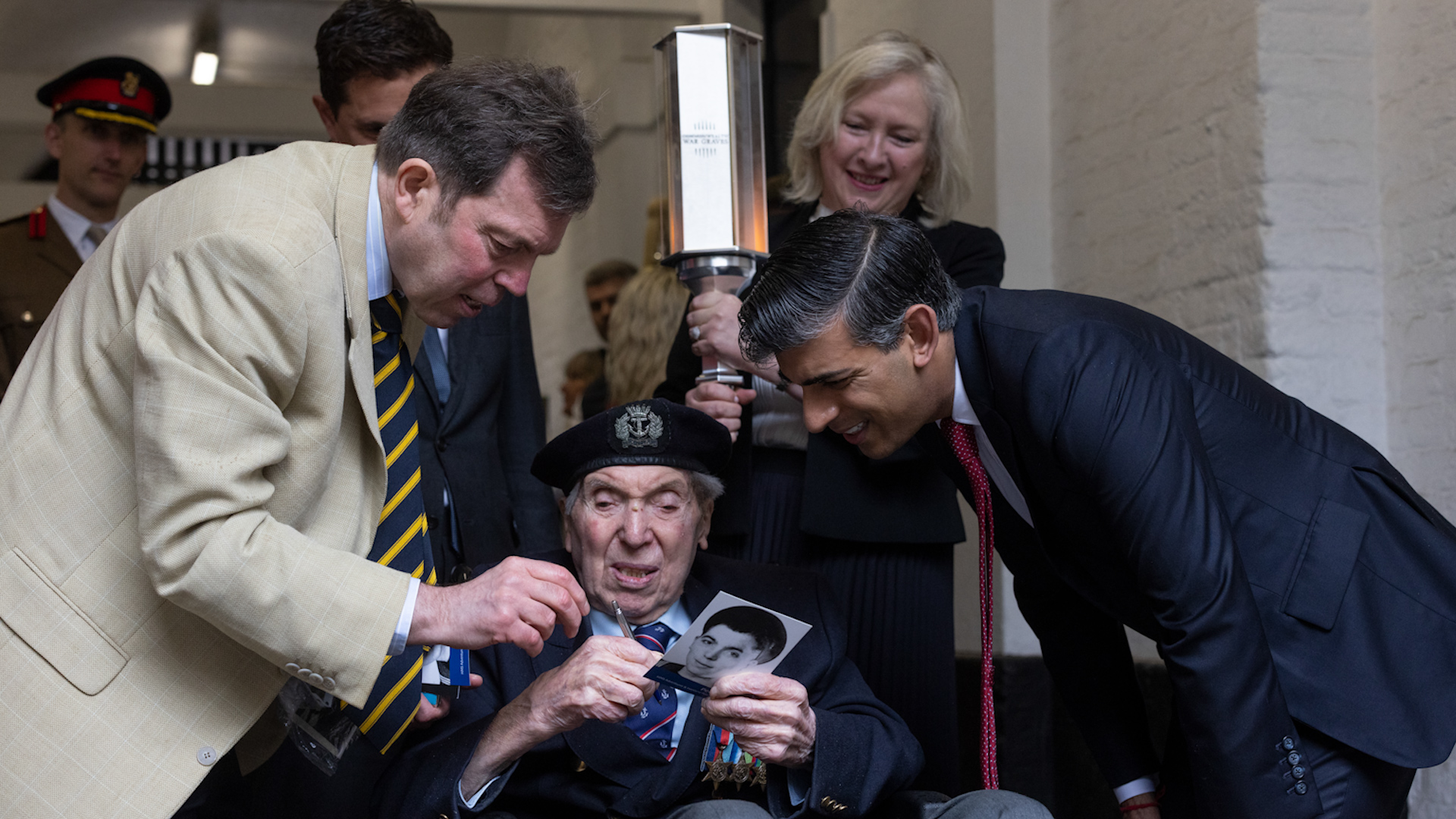 Prime Minister Rishi Sunak, with D-Day veteran Peter Kent and his son Steven, at Horse Guards, with dday torch 14052024 CREDIT MOD
