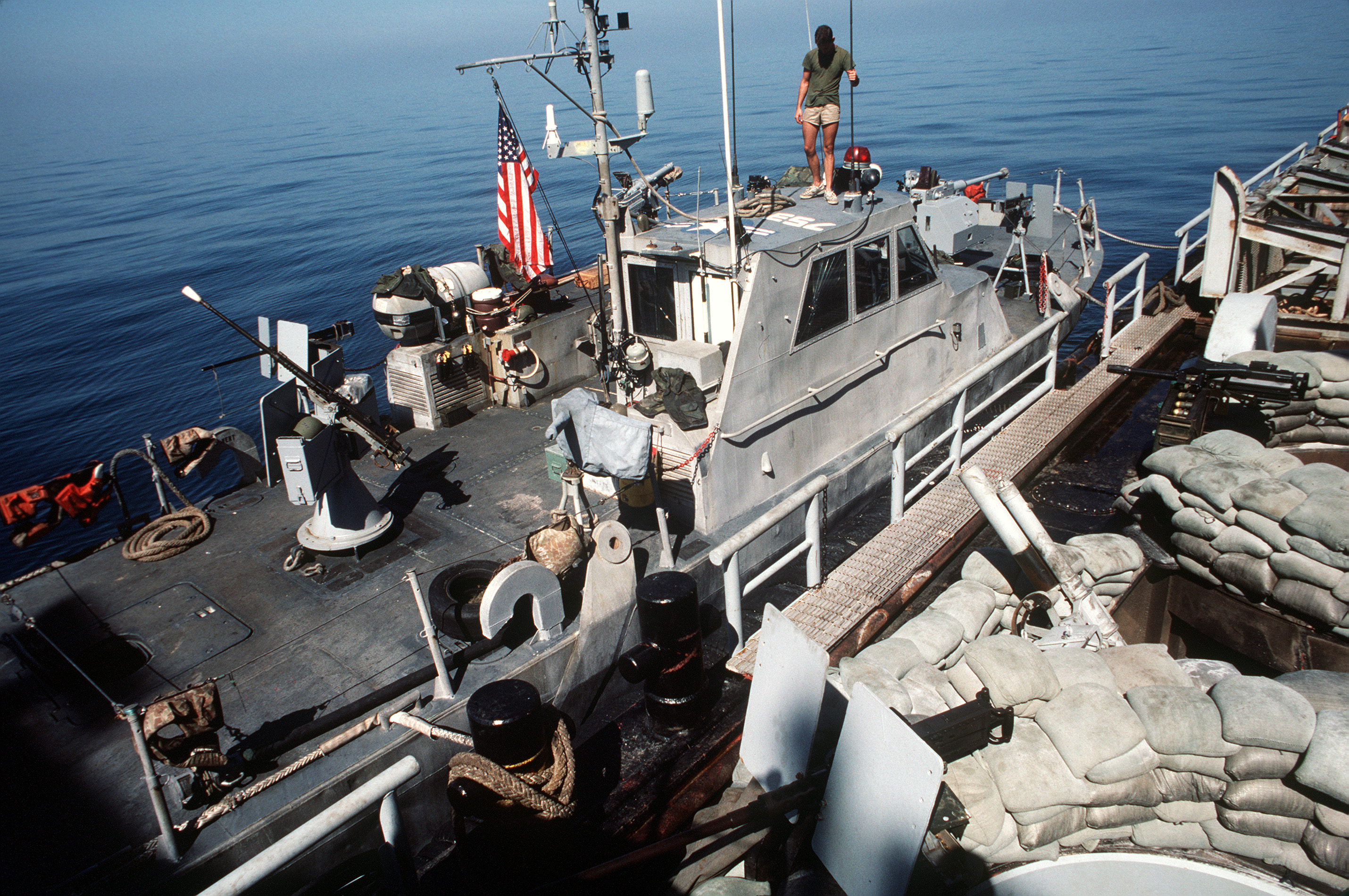 US Navy patrol boat tied up to US barge being used for combat operations. (Image: US Navy)