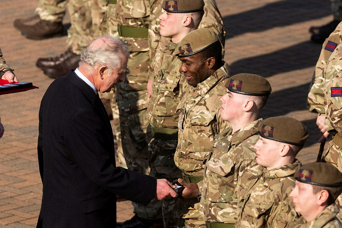 Prince Charles giving medals to members of the Welsh Guards