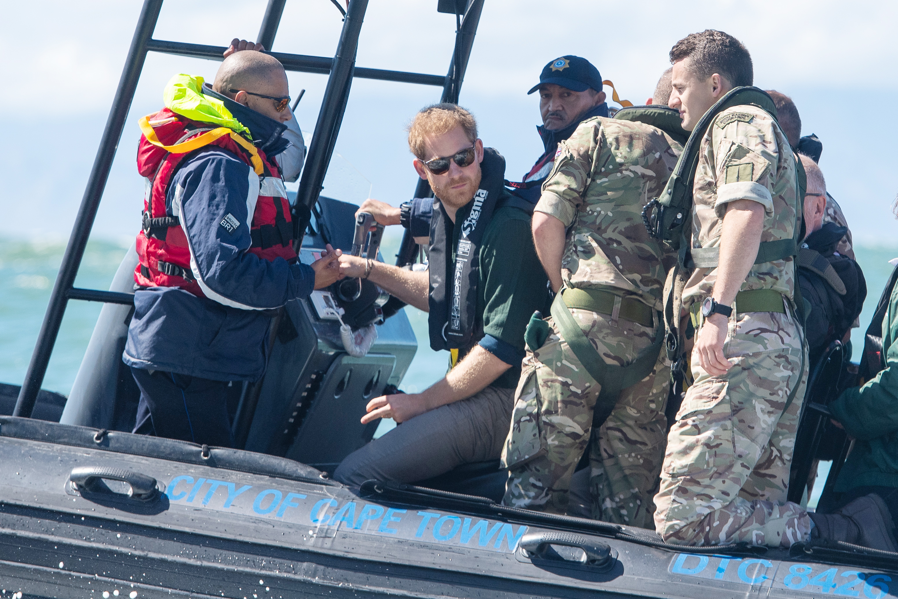 Prince Harry travelled along the coastline of Kalk Bay Harbour, south of Cape Town (Picture: PA).